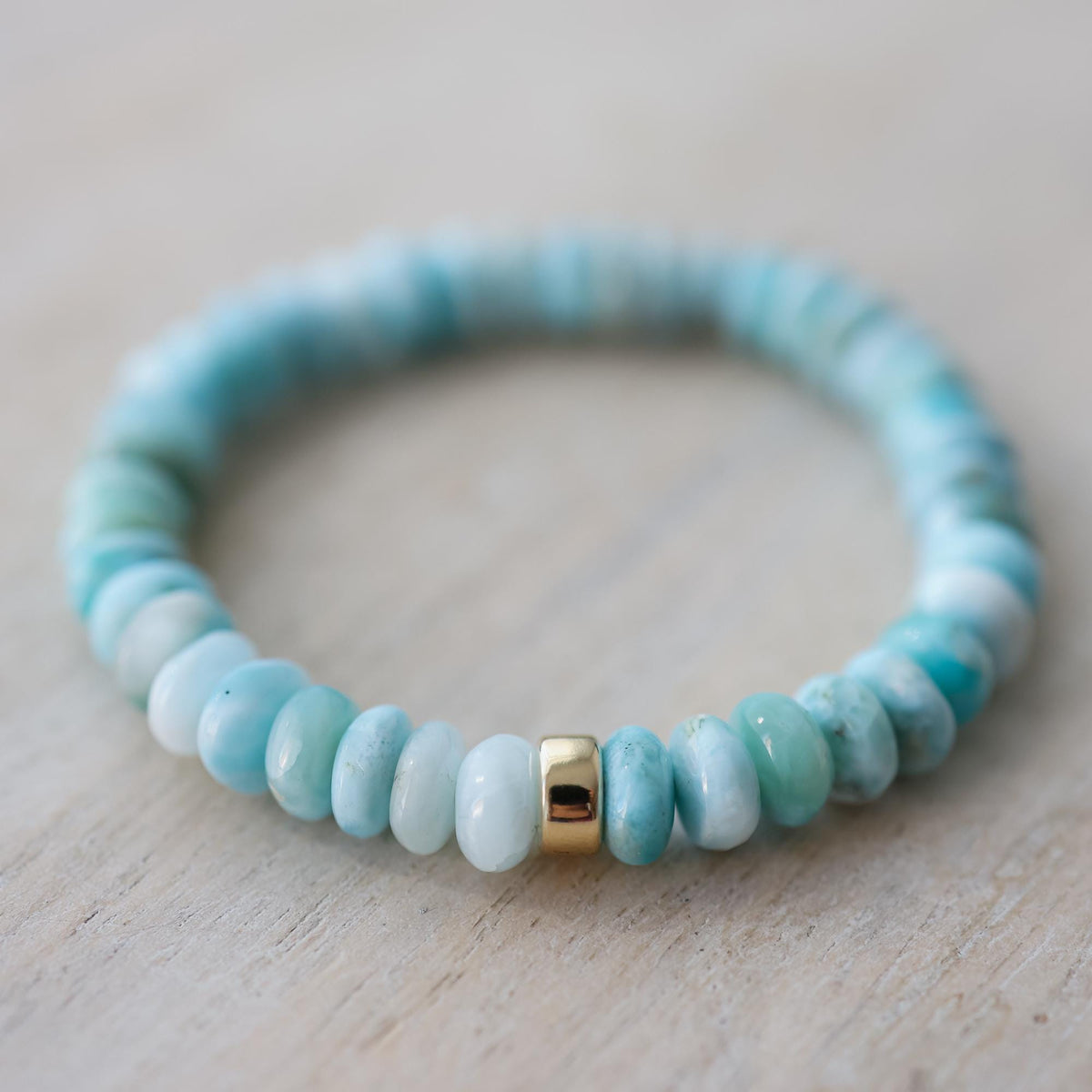 Larimar Rondel Bracelet featuring blue gemstone beads from Earthly Abundance, displayed on a neutral background.