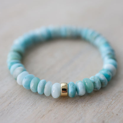 Larimar Rondel Bracelet featuring blue gemstone beads from Earthly Abundance, displayed on a neutral background.