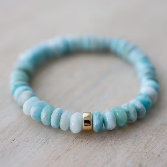 Larimar Rondel Bracelet featuring blue gemstone beads from Earthly Abundance, displayed on a neutral background.
