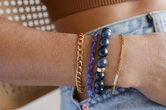 10mm Dumortierite bracelet by Earthly Abundance featuring polished blue stones with natural variations and silver-tone clasp.