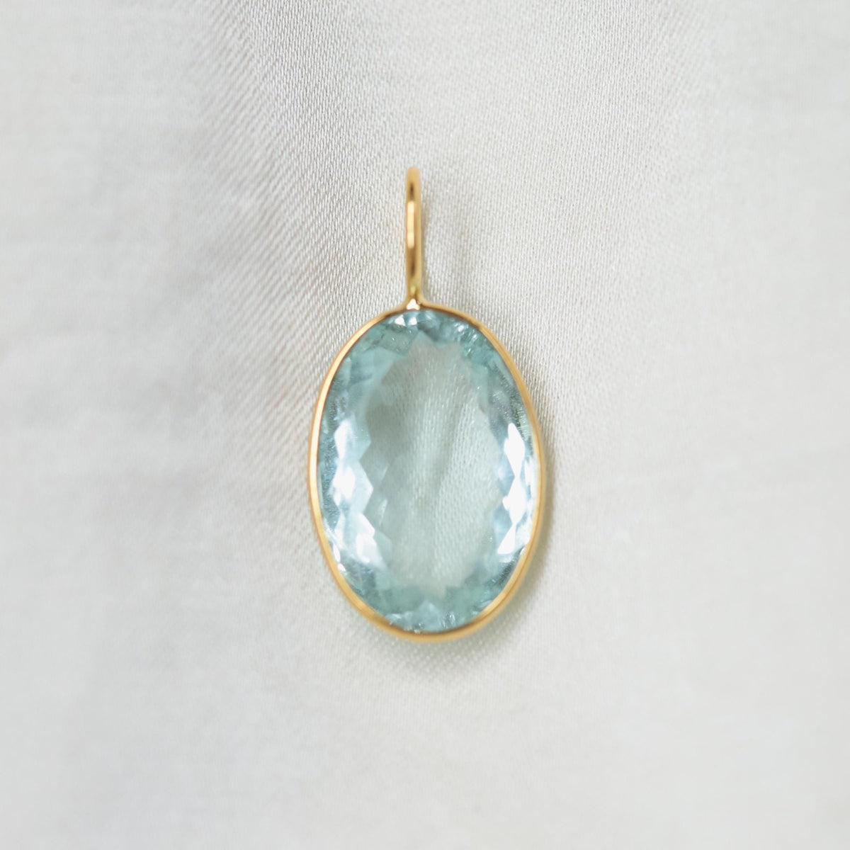 Aquamarine and solid 14K gold Ocean Light jewelry piece by Earthly Abundance with aquamarine gemstone and gold setting.