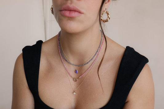 14K Tanzanite Singapore chain necklace featuring a vibrant tanzanite gemstone, crafted by Earthly Abundance.