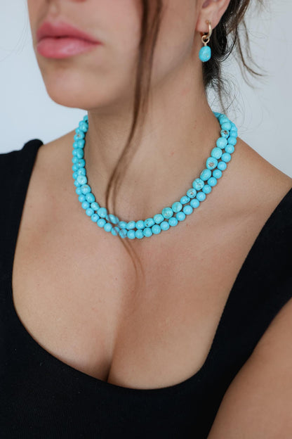 Earthly Abundance Sleeping Beauty hoops earrings with vibrant pink and red gemstone accents on gold hoops.