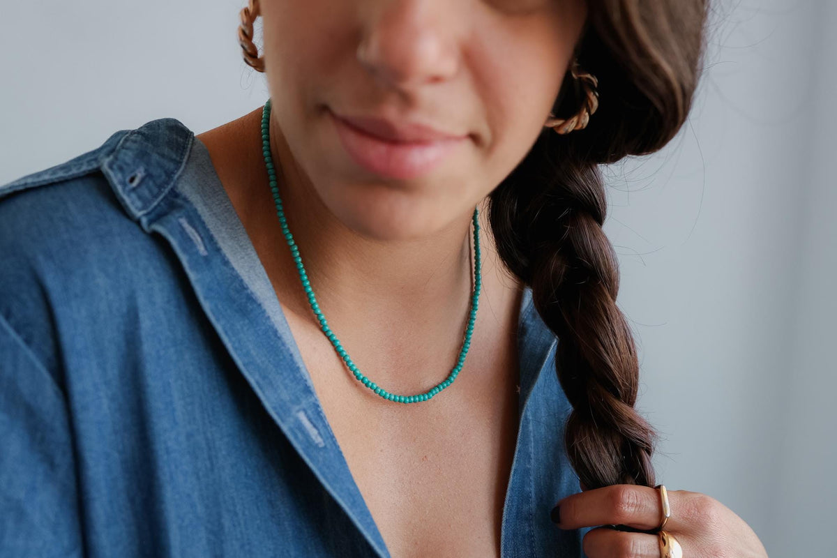 Kingman turquoise necklace with 14K gold setting by Earthly Abundance Jewelry, featuring vibrant turquoise stones on a delicate chain.