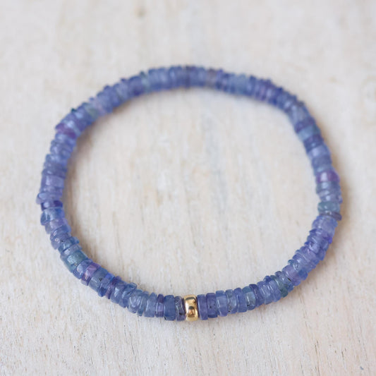 Earthly Abundance tanzanite stretch bracelet featuring vibrant blue-purple tanzanite beads on an elastic band.