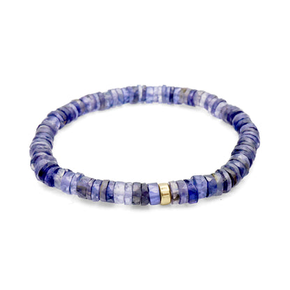 Iolite Heishi bracelet with 5mm beads from Earthly Abundance, featuring round, smooth violet-blue stones on an elastic band.