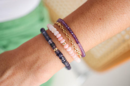 Iolite Heishi bracelet with 5mm round beads from Earthly Abundance, featuring alternating blue and gray tones on a white background.