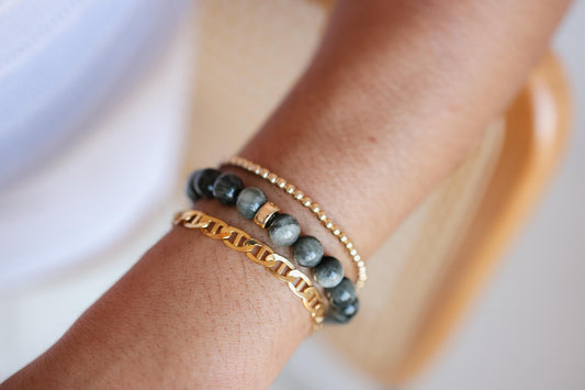 8mm Cats Eye bracelet by Earthly Abundance featuring smooth, round beads with a glossy, reflective surface.