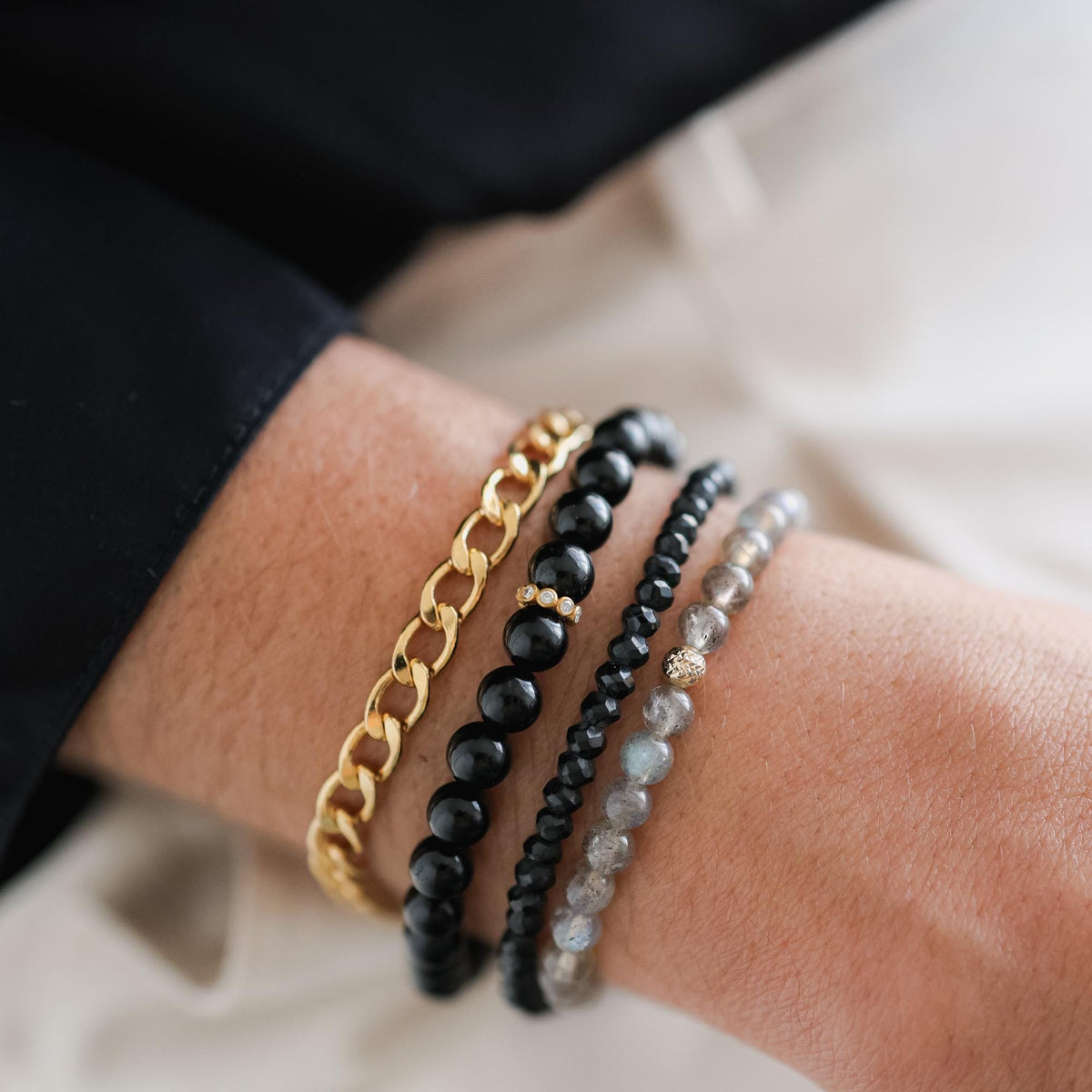 Black and gold Black Spinel bracelet by Earthly Abundance featuring sleek black stones with gold accents on a delicate chain.