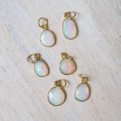 Ethiopian Opal Necklace featuring a 14K gold chain and vibrant opal pendant, showcased on a neutral background.