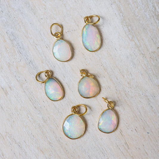 Ethiopian Opal Necklace featuring a 14K gold chain and vibrant opal pendant, showcased on a neutral background.