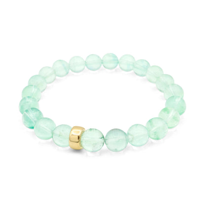 Sea glass green fluorite bracelet featuring smooth, polished stones on a stretchy cord, designed by Earthly Abundance.