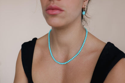 Sleeping Beauty turquoise necklace with 5.5mm beads in solid 14K gold chain, featuring a vibrant blue turquoise pendant.