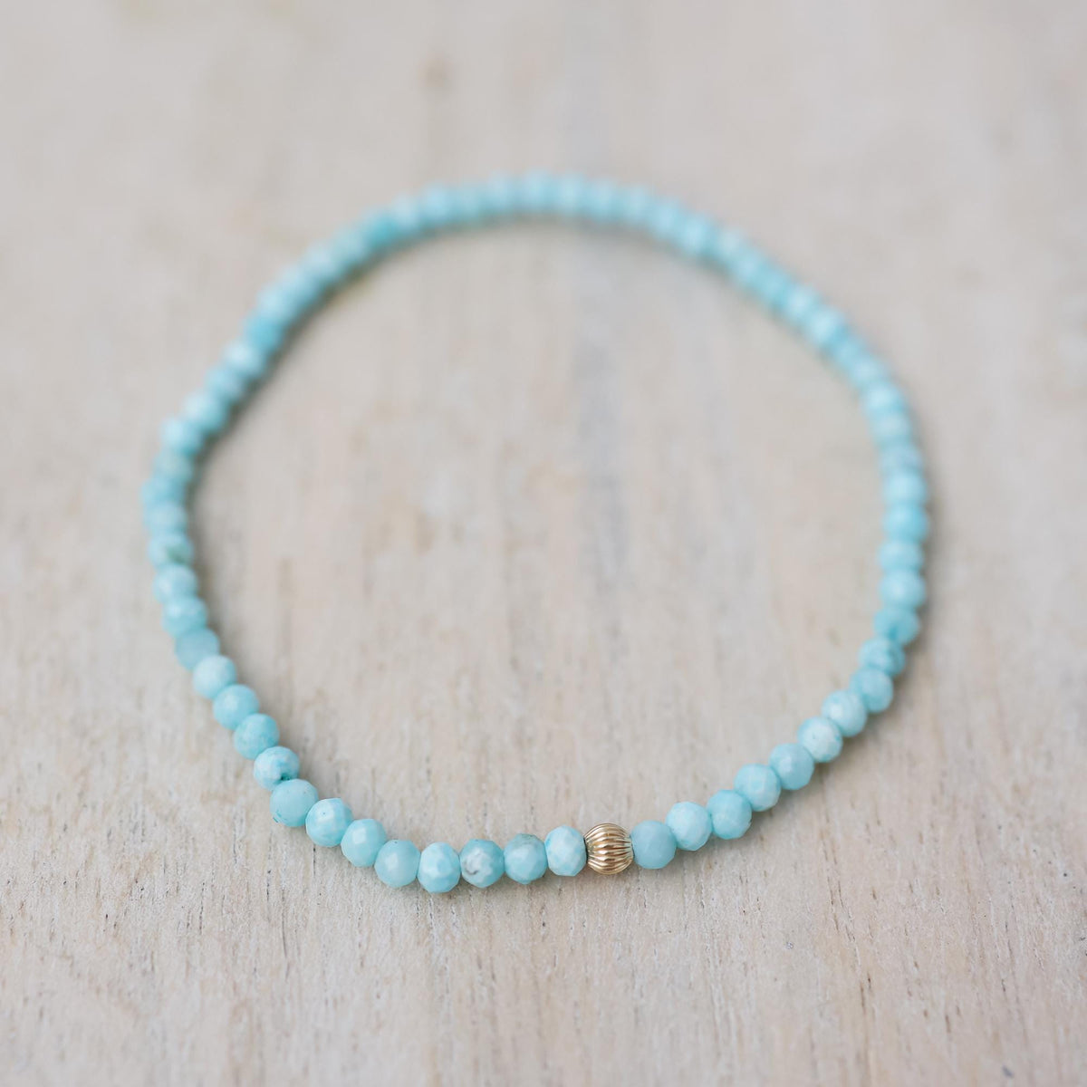 Serene Calm Larimar bracelet with 14K gold accents from Earthly Abundance, featuring smooth blue larimar stones and elegant design.