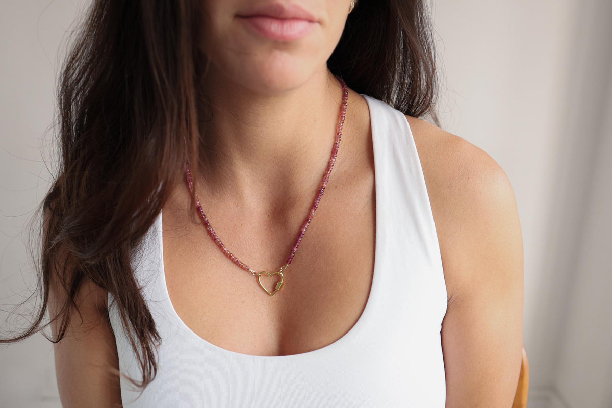 Raspberry tourmaline heart carabiner necklace by Earthly Abundance, featuring a polished pink gemstone pendant