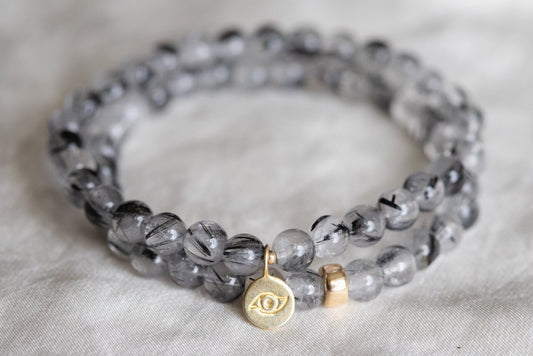 Black rutilated quartz with evil eye charm
